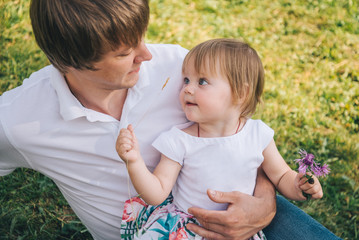 Happy loving family Father and his daughter are playing and hugging outdoors.