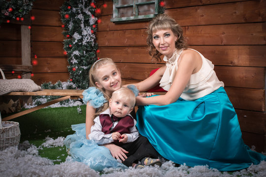 Mother and children in the room before Christmas and New Year
