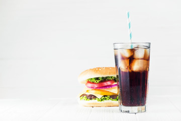 Cold glass of cola and big burger