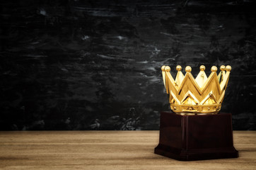 image of golden crown award over wooden table