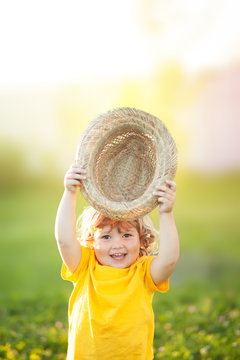 Adorable happy todder girl with staw hat, little farmer