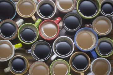 coffee time - many cups of coffee on wooden table good background for text or graphic design. coffee lover - lots of coffee cup in different cups - top view