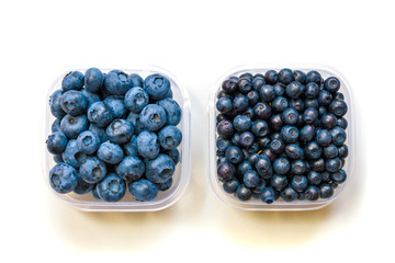Glass bowl with blueberries on white background top view