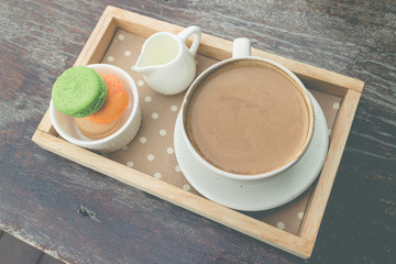 hot coffee breakfast set with fresh macaroon in outdoor bakery house cafe(vintage)