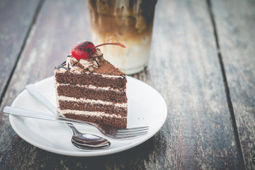 chocolate cake with cherry topping and ice coffee mocha in outdoor cafe