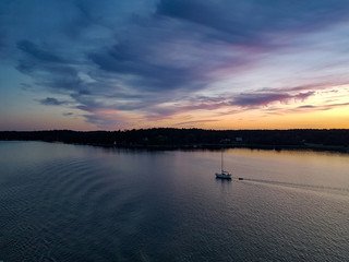 Sunset at archipelago of sweden with small boat