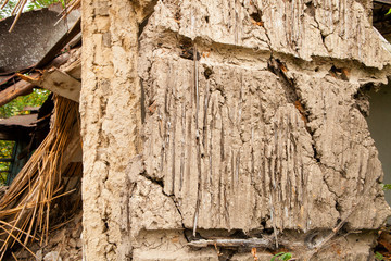 The old and collapsing wall of a house made of clay