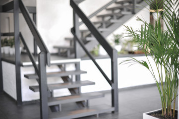 A stylish interior of a cozy cafe. Elements of interior. Original staircase
