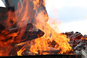 Iron metal structures covered with a bright flame of fire from containers