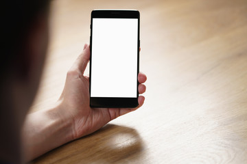 young man hand holding smartphone with blank white screen