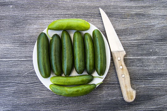 Fresh cucumber pictures on a white background, natural and organic cucumbers, cucumber pictures cut with a knife in a basket,

