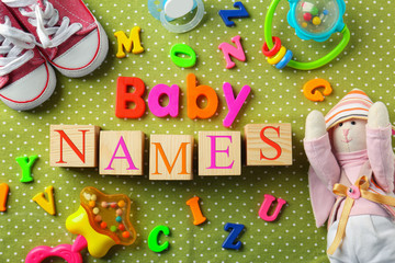 Composition with text BABY NAMES on color background