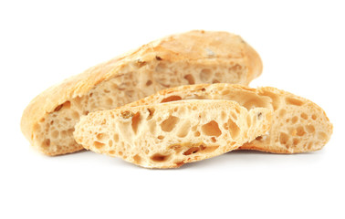 Loaf and two slices of bread on white background