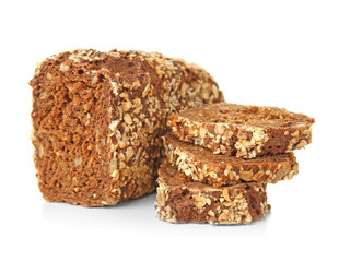 Loaf and three slices of bread with cereals on white background