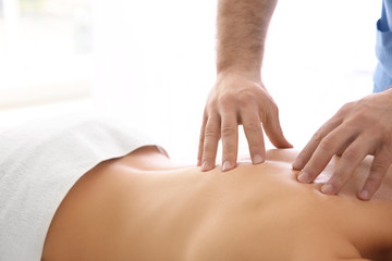 Physiotherapist working with patient on white background. Physiotherapy concept