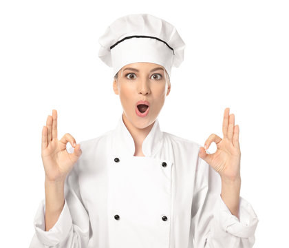 Young female chef on white background