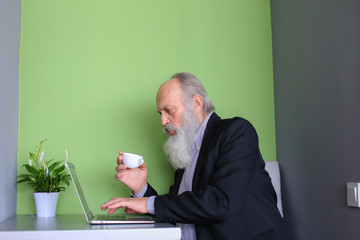 Experienced businessmen retired communicates via skype using gad © sisterspro