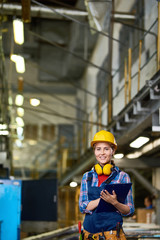 Female Factory Worker Smiling at Camera