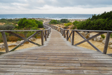 Fototapeta premium Wooden walkway giving access to the beach of La Barrosa in Sancti Petri, Cadiz, Spain.