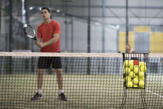 Paddle tennis basket on focus and blurred player uin background