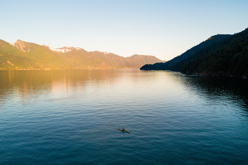 Aerial shot of kayaker on lake with mountains while  sunset - 167653033