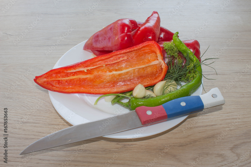 Wall mural plate with fresh vegetables on table. green and red bell pepper backgro