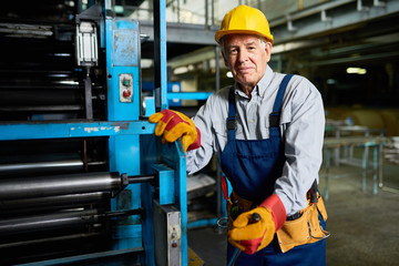 Senior Man operating Machines at Factory