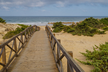 Fototapeta na wymiar Sand dunes between hotels and beach of La Barrosa in Sancti Petri, Cadiz, Spain