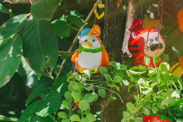 Colorful animal ceramic doll hanging in the garden