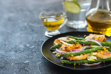 Salad with fried halloumi, asparagus and orange zest. Copy space