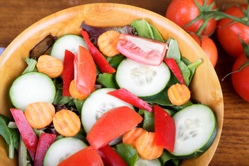 Large Mixed Salad in Wood Bowl with Fresh Tomatoes