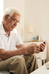 Obraz premium Senior Man Learning to Use Smartphone