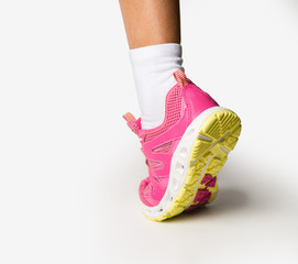 Pink sneakers on a light.