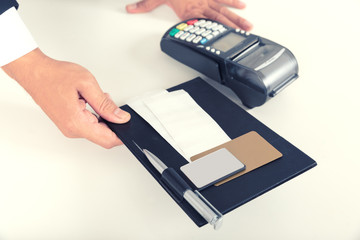 Seller give consumer signing on a sale transaction receipt with Credit Card Machine.