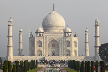 Fototapeta premium Amazing view on the Taj Mahal in sunset light with reflection in water. The Taj Mahal is an ivory-white marble mausoleum on the south bank of the Yamuna river. Agra, Uttar Pradesh, India.
