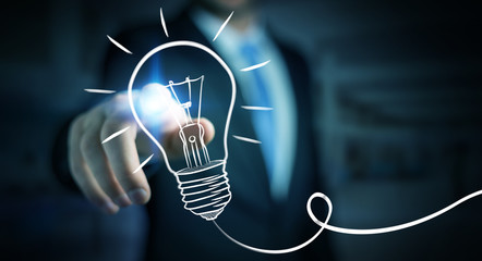 Businessman touching a sketch lightbulb