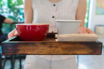 a waitress serving the art latte coffee