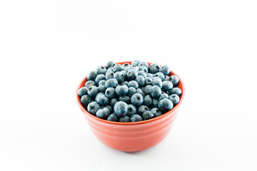 Red bowl full of fresh juicy blueberries