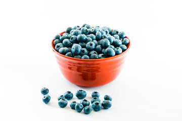 Red bowl full of fresh juicy blueberries