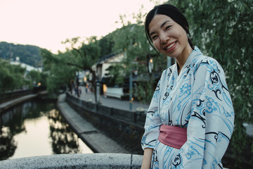 an asian girl smiling and wearing Yukata