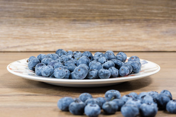 bowl with flowers full of fresh juicy blueberries
