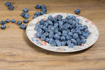 bowl with flowers full of fresh juicy blueberries