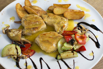 Grilled chicken breast with vegetables and sauce on a plate. Traditional cuisine. Grill kitchen.
