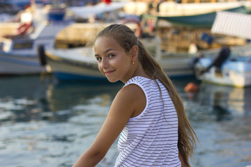 Pretty young girl near the Mediterranean sea looking forward . Antalya, Turkey, marina