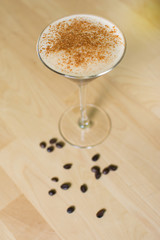 Cocktail on a wooden table. Coffee cocktail on a bar table.