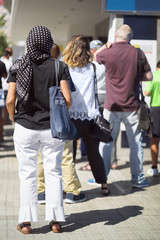 Fototapeta premium people queue in line and woman with headscarf hiyab , selective focus
