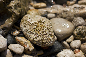Fototapeta na wymiar Stones on the beach at the sea under water