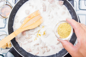 Chef putting green curry powder for cooking