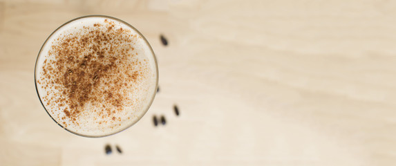 Cocktail on a wooden table. Coffee cocktail on a bar table.