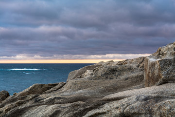 Scenics View of Rocks Coast Against Sea and Clouds